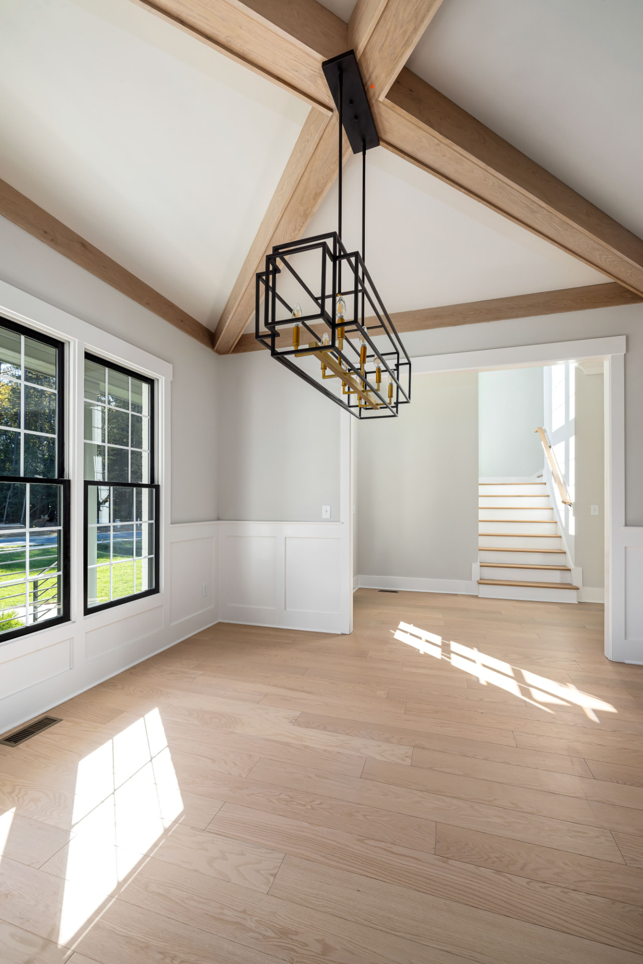 Bright, freshly cleaned open-plan living room with high ceilings